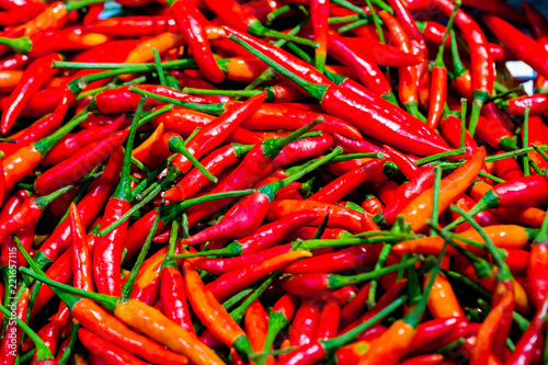 Pile of fresh red chilli peppers texture. Raw food background. Close up. Traditional vegetable market.lose-up of some red chillies mixed.