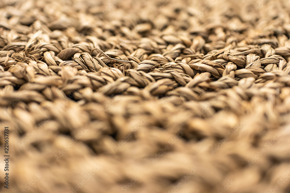 Texture closeup of weaving from straw, focus with shallow depth of field, blurred background