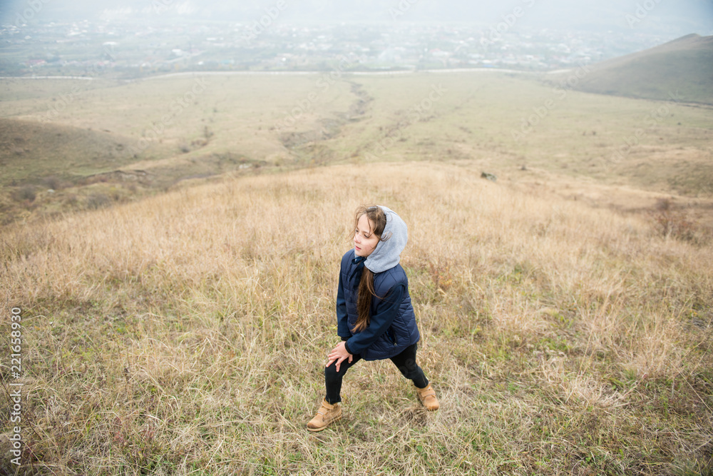 sport little girl in jacket hood during hiking in countryside autumn mountains sport little girl in jacket hood during hiking in countryside autumn mountains