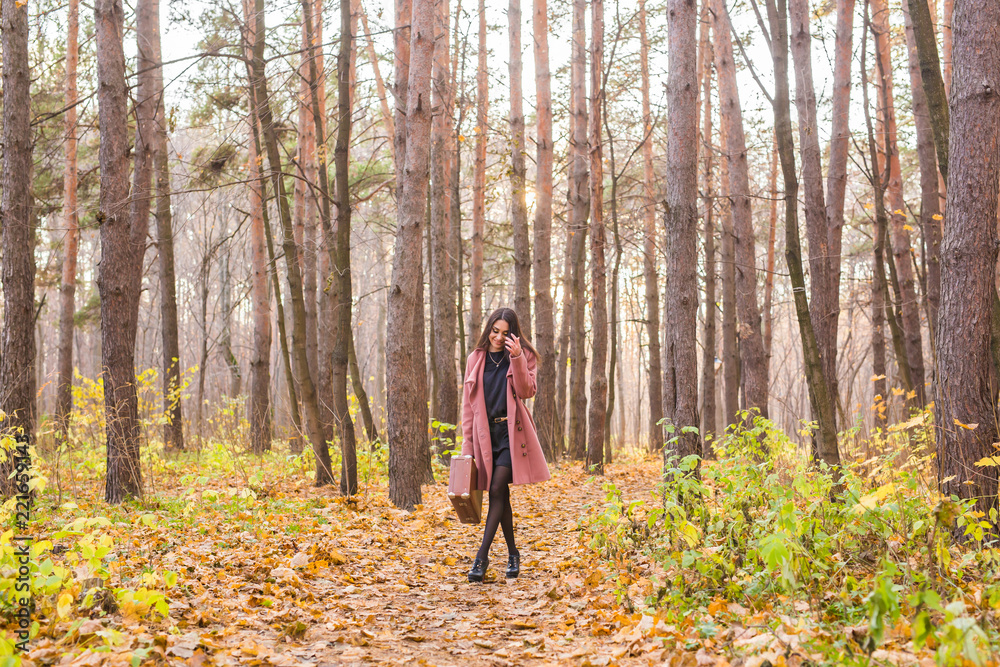 Season, fall and people concept - beautiful young woman walking in autumn park Season, fall and people concept - beautiful young woman walking in autumn park