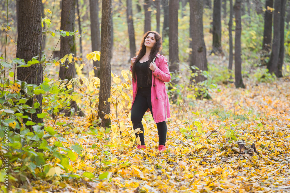 Nature, season and fashion concept - Portrait of beautiful plus size woman in pink coat