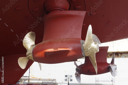 Double propellers on a massive supply vessel. Ship in a dry dock for repairs and annual survey.