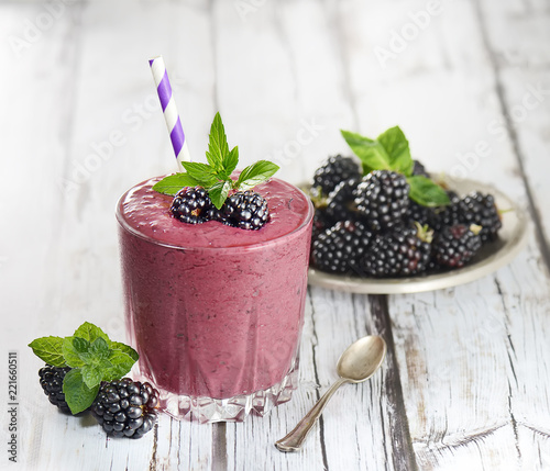 blackberry smoothies juice a tasty healthy drink in a glass, drink the morning on white wooden background.