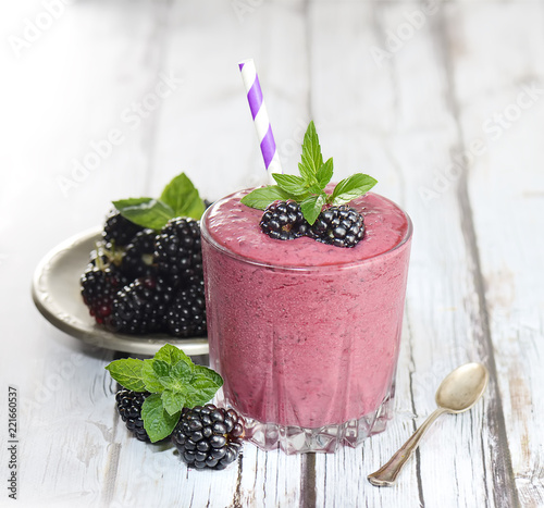 blackberry smoothies juice a tasty healthy drink in a glass, drink the morning on white wooden background.