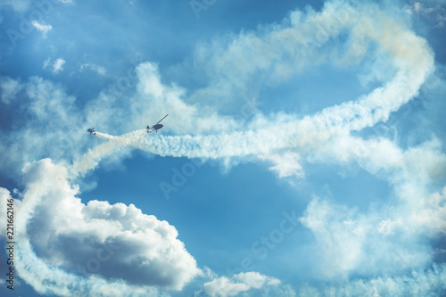 Fototapeta Naklejka Na Ścianę i Meble -  Gyrocopter or autogyro in flight in the blue sky at Air Show Mazury 2018 event at the lake Niegocin in Gizycko. Poland.