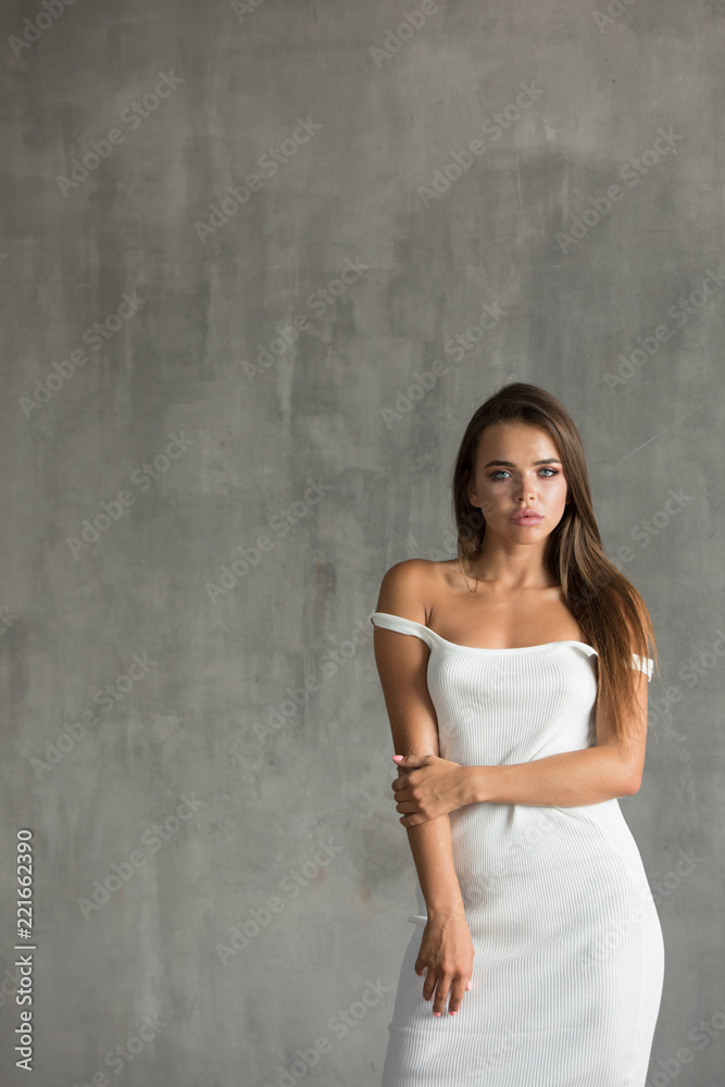 Beautiful sexy woman in white skin-tight dress. Beautiful sexy woman in white skin-tight dress.