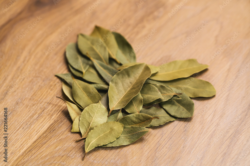 Dry bay leaves on oak wood table Dry bay leaves on oak wood table