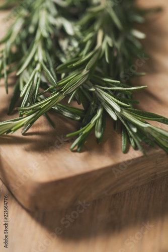 fresh rosemary bunch on wood board