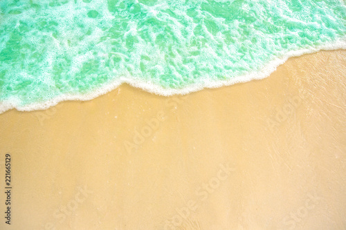 soft wave of blue ocean on sandy beach. background. selective focus. beach and tropical sea white foam on beach. soft focus on bottom of picture.