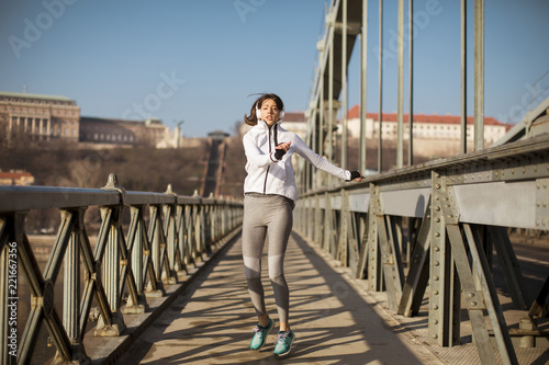 Young sportswoman stretching and preparing to run