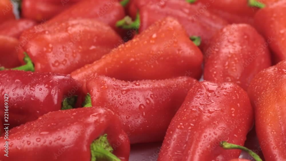 Close-up. Rotation of natural ripe red peppers in drops of dew. Food Close-up. Rotation of natural ripe red peppers in drops of dew. Food