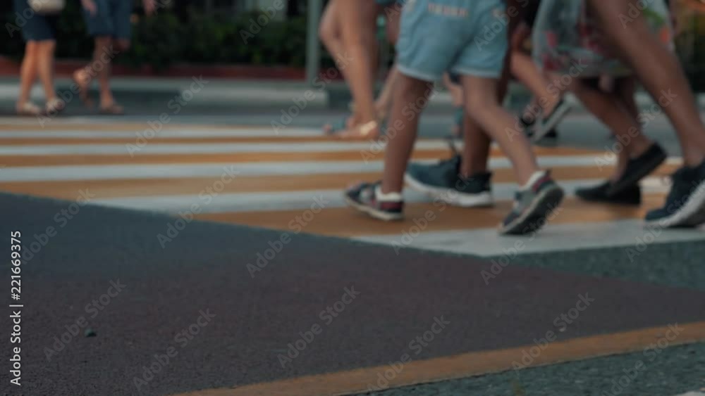 People walk through the zebra crossing. Fast secure highway crossing People walk through the zebra crossing. Fast secure highway crossing