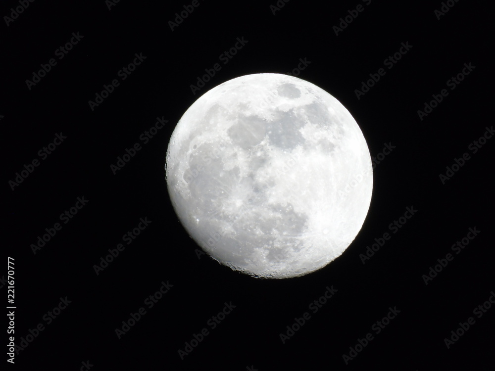 An amazing photography of the full moonlight under a dark sky with some small stars in the background An amazing photography of the full moonlight under a dark sky with some small stars in the background