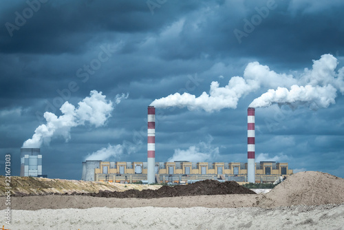 Coal ower plant smokestacks emitting smoke by chimneys