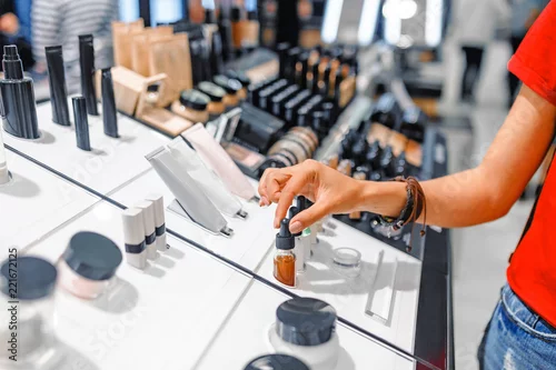 Obraz woman chooses cosmetics and make-up products in a store