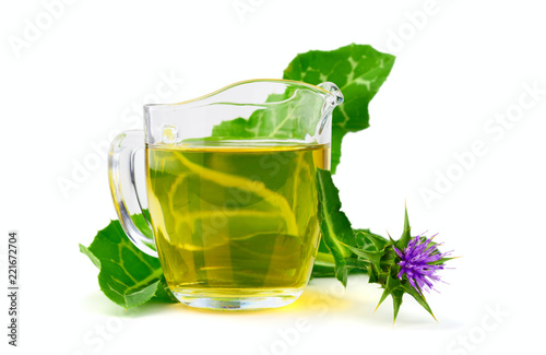 Milk Thistle Herbal Tea Extract Tincture in a Glass. Isolated on White Background. photo