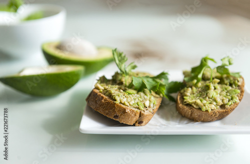 sandwiches with bread and avocado, a sprig of parsley, useful tasty food