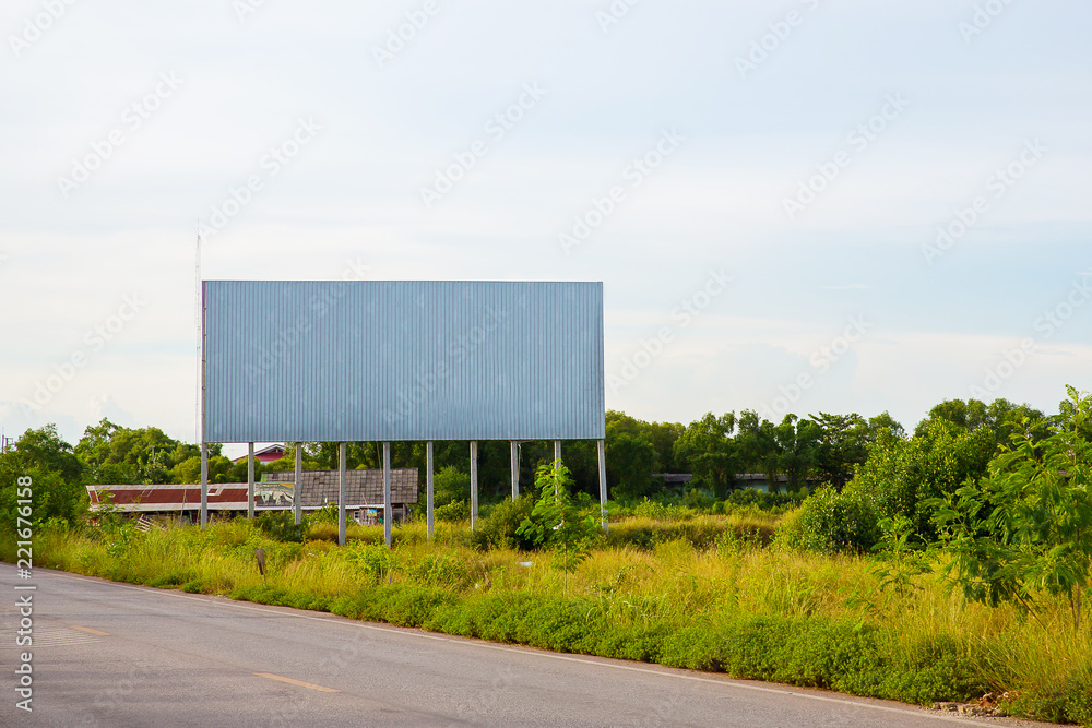 blank billboard on the sideway in the park. image for copy space, advertisement, text and object. white billboard in natural green. blank billboard on the sideway in the park. image for copy space, advertisement, text and object. white billboard in natural green.