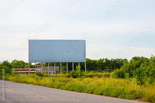 blank billboard on the sideway in the park. image for copy space, advertisement, text and object. white billboard in natural green.