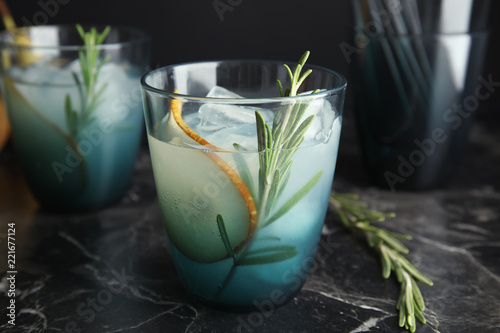 Tasty refreshing pear cocktail with rosemary on table
