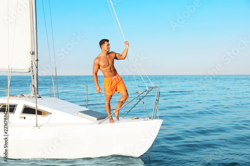 Young man relaxing on yacht during sea trip