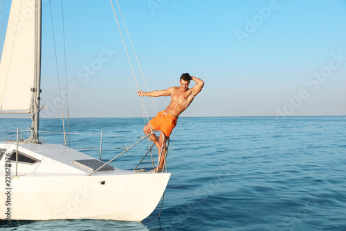 Young man relaxing on yacht during sea trip
