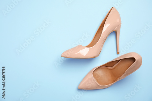 Pair of beautiful shoes and space for text on color background, top view