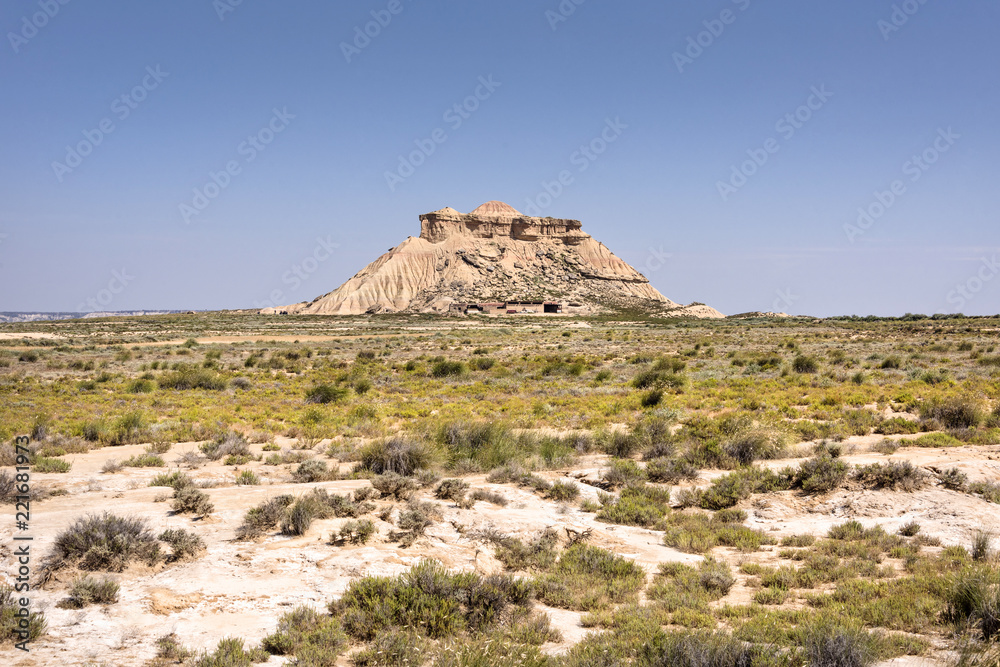 Spain, Bardenas Reales: Panorama view of famous Spanish natural semi desert sierra natural preserve park with Pisquerra rocky mountain chain, wide plains and blue sky - concept travel nature badlands Spain, Bardenas Reales: Panorama view of famous Spanish natural semi desert sierra natural preserve park with Pisquerra rocky mountain chain, wide plains and blue sky - concept travel nature badlands
