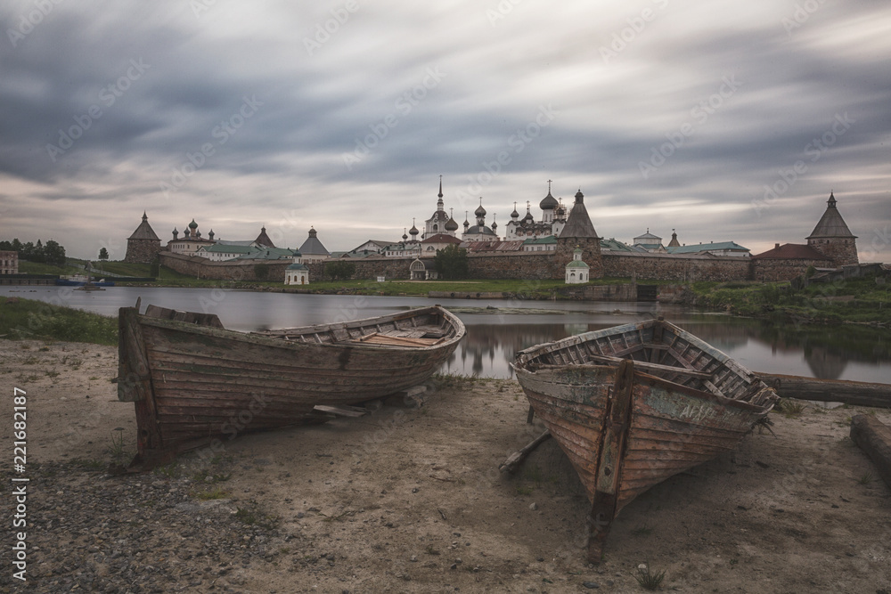 Two old wooden boats on the background of the Solovetsky Monastery, Russia