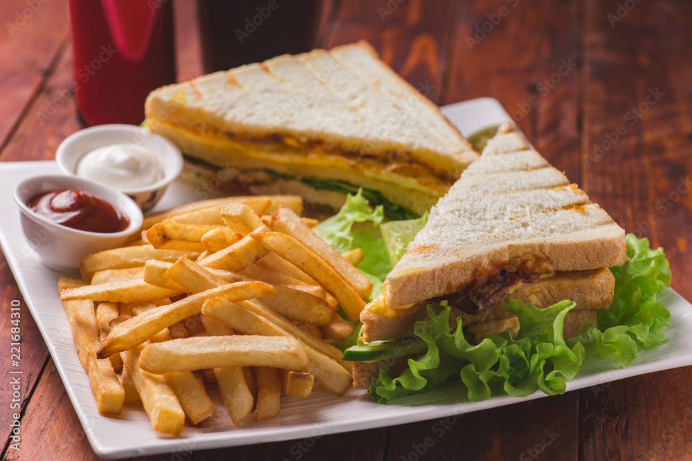 Club sandwich served with french fries and soda Stock Photo | Adobe Stock