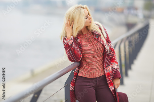 Portrait close up of young beautiful woman, on background autumn city