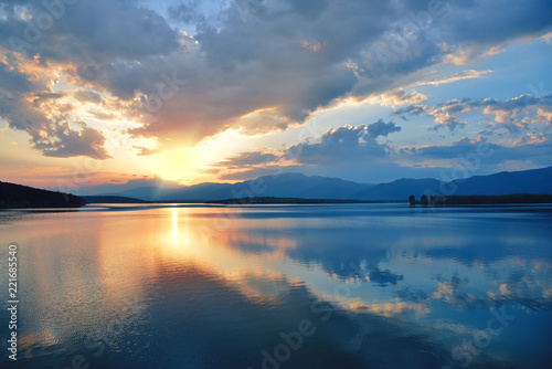 Incredibly beautiful sunset.Sun  sky lake.Sunset or sunrise landscape  panorama of beautiful nature. Sky with amazing colorful clouds. Water reflections.Magic Artistic Wallpaper.Dream  line.Creative.