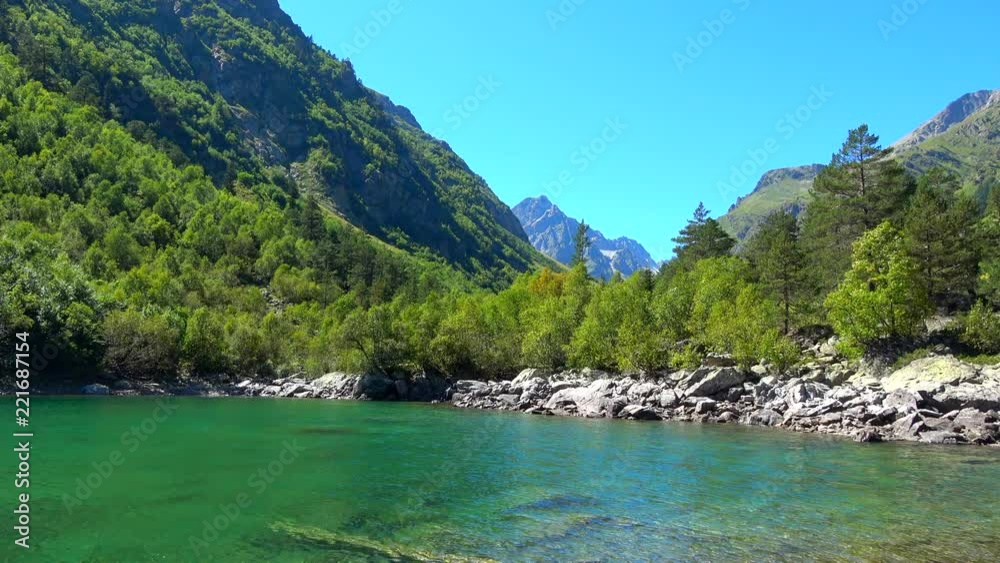 View lake scenes in mountains, national park Dombai, Caucasus, Russia, Europe. Summer landscape, sunshine weather, blue sky and sunny day View lake scenes in mountains, national park Dombai, Caucasus, Russia, Europe. Summer landscape, sunshine weather, blue sky and sunny day