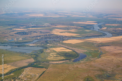 Fields, meadows, swamps, a river and several villages shown from from a birds eye view © ovbelov1972