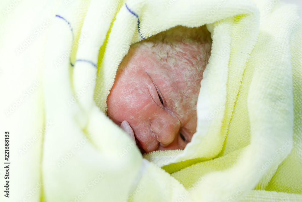 Newborn child seconds and minutes after birth. Cute tiny new born baby girl  on towel. New life, beginning, healthcare Stock Photo by ©romrodinka  212993292