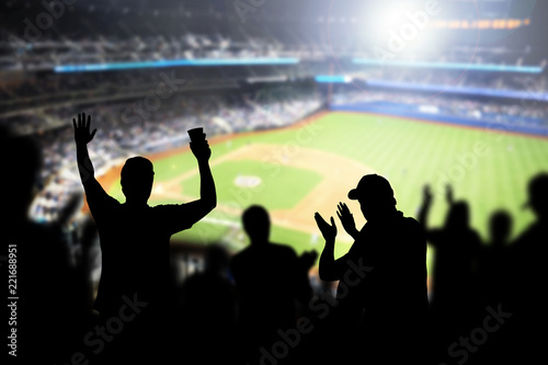 Baseball fans and crowd cheering in stadium and watching the game in ballpark. Happy people enjoying a match and sport event in arena. Friends watching ballgame live. photo