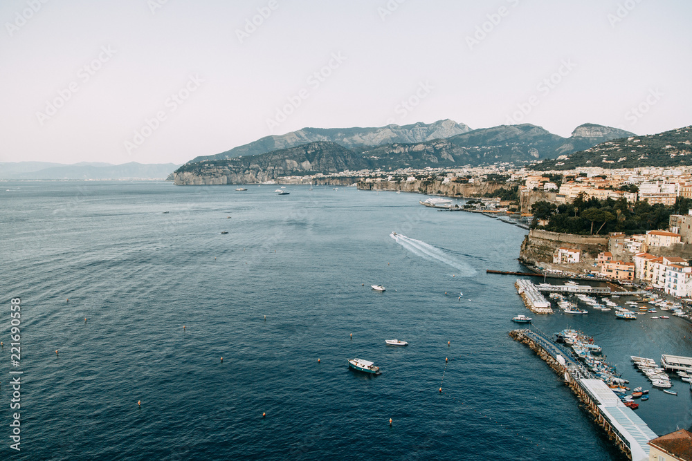 Views of the city of Sorrento in Italy, panorama and top view. Night and day, the streets and the coast. Beautiful landscape and brick roofs. Architecture and monuments of antiquity. Shops and street