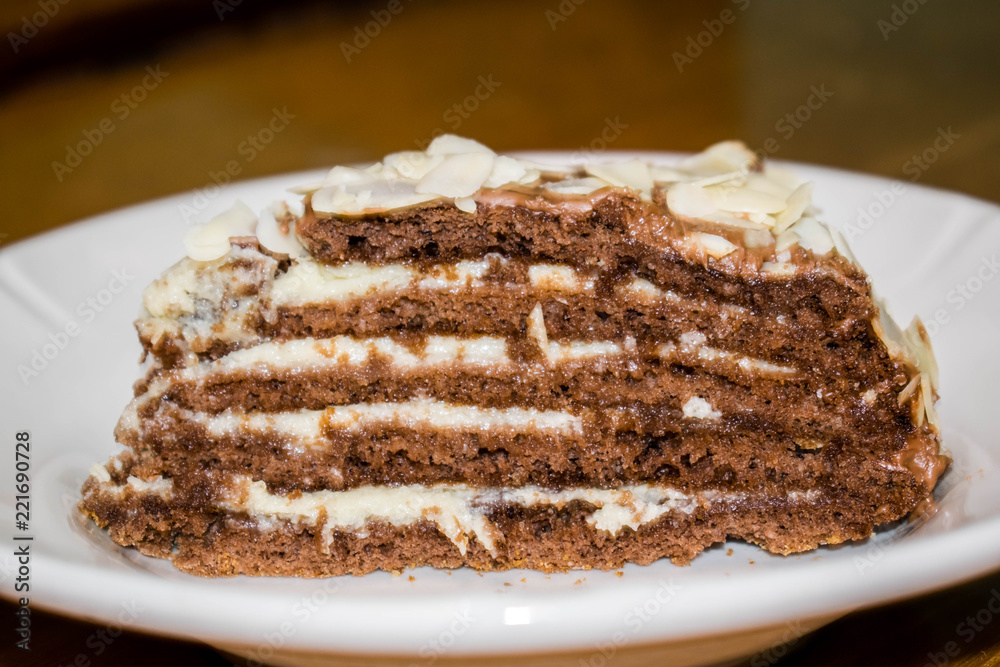 A cake biscuit honey cake slice on a plate one for a background A cake biscuit honey cake slice on a plate one for a background
