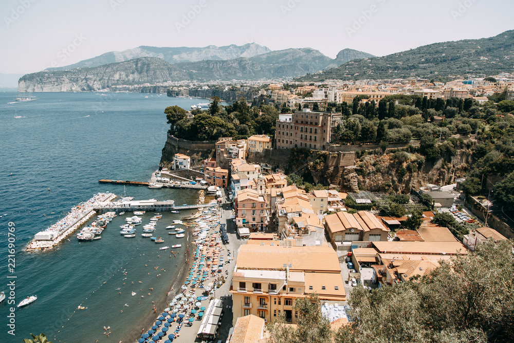 Fototapeta premium Views of the city of Sorrento in Italy, panorama and top view. Night and day, the streets and the coast. Beautiful landscape and brick roofs. Architecture and monuments of antiquity. Shops and street