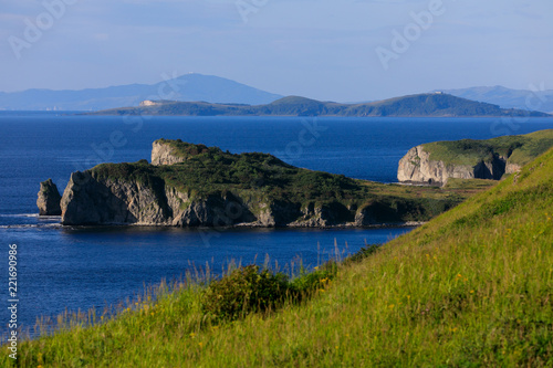 A colorful dawn at Cape Bruce in Slavyanka, in the Khasansky district of Primorsky Krai. Cape Bruce - it's high cliffs, clear sea and green grass on the hills