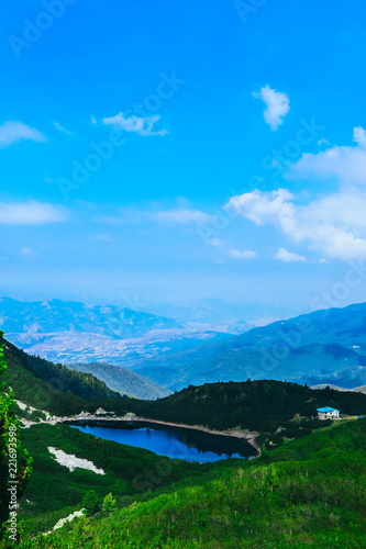 Amazing alpine mountain landscape  cottage and lake. Europe  Bulgaria  Pirin mountains.