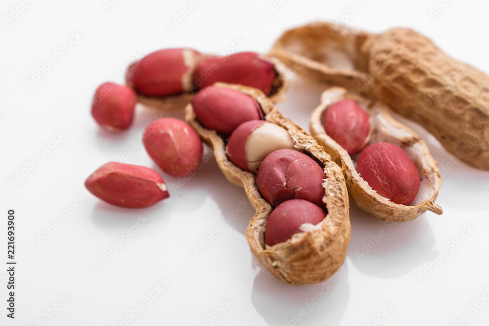 fresh peanuts on a white acrylic background fresh peanuts on a white acrylic background