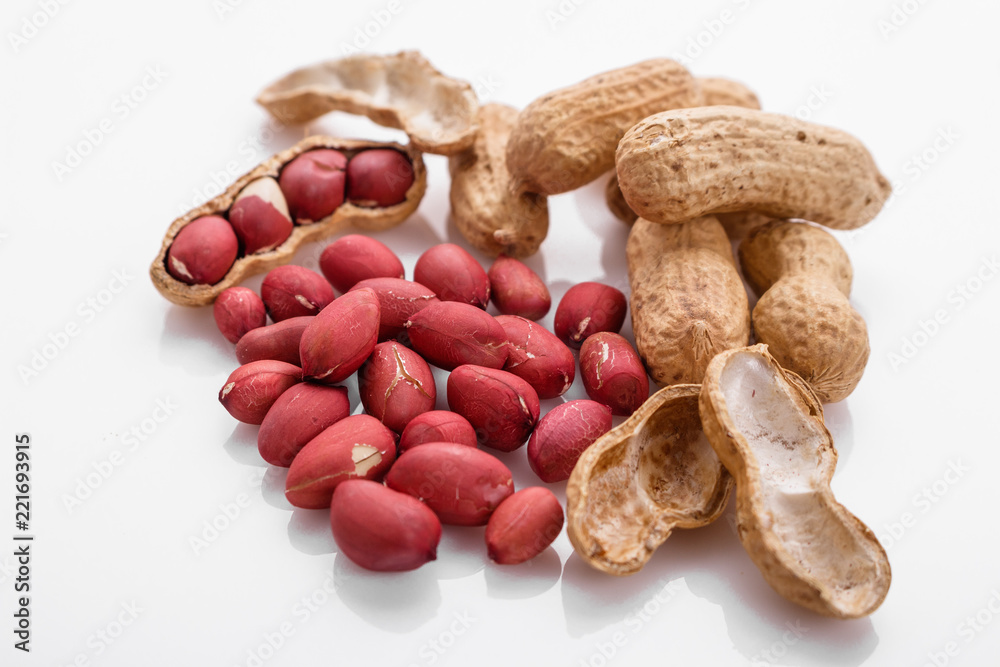 fresh peanuts on a white acrylic background fresh peanuts on a white acrylic background