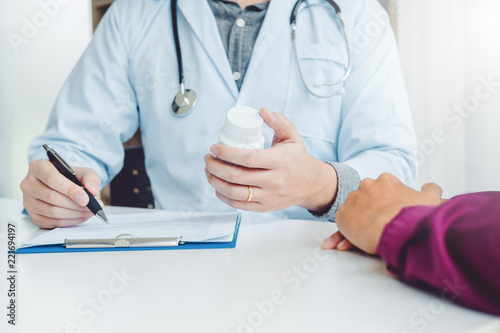 Doctor or physician recommend pills medical prescription to male Patient