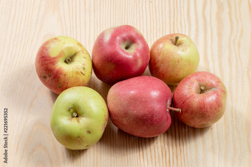 Bunch of ripe apples on a wooden table Bunch of ripe apples on a wooden table