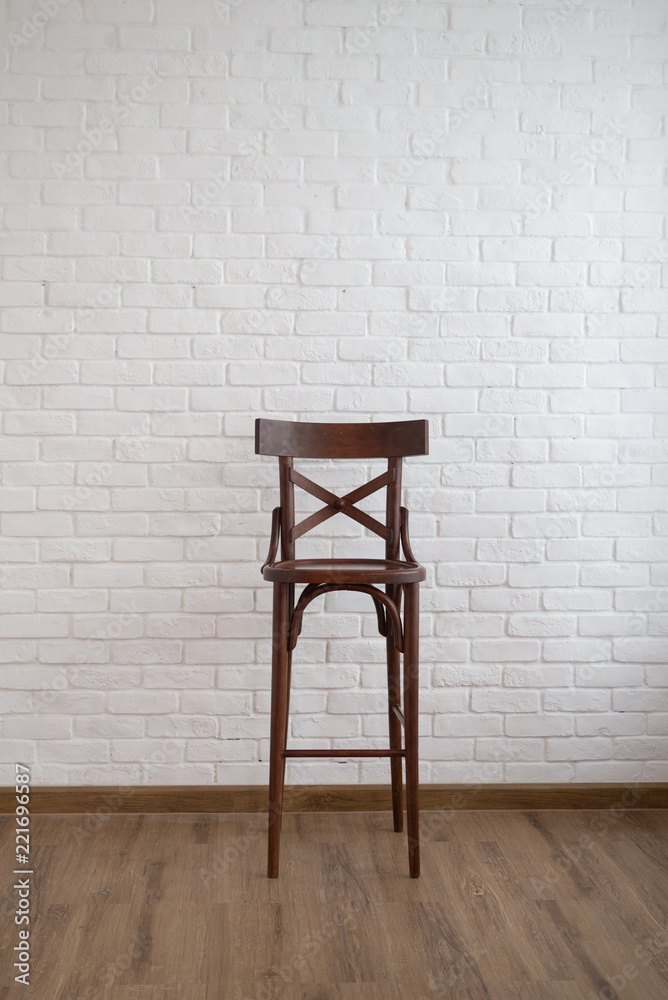 Dark brown wooden high chair with white brick wall decoration interior