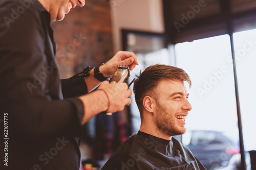 Handsome man at the hairdresser getting a new haircut