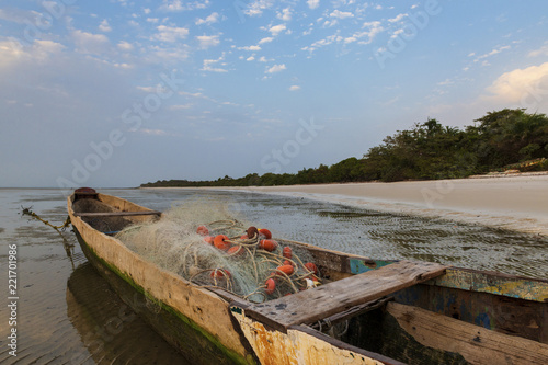 Obraz na plátně Traditional fishing canoe at the beach in the island of Orango at sunset, in Guinea Bissau