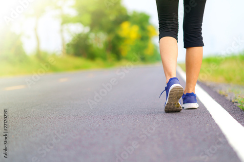 Woman legs walking in the park, Female runner running on the road outside