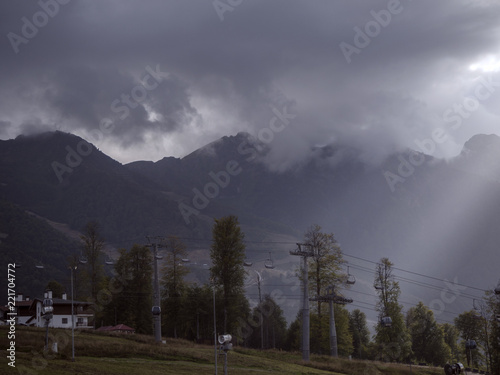 The rays of the sun through the clouds on the background of the mountains Krasnaya Polyana Sochi